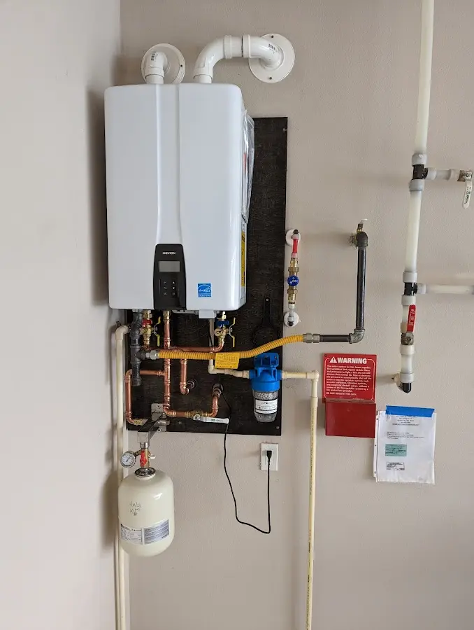 Professional plumber installing copper piping in a Galloway home